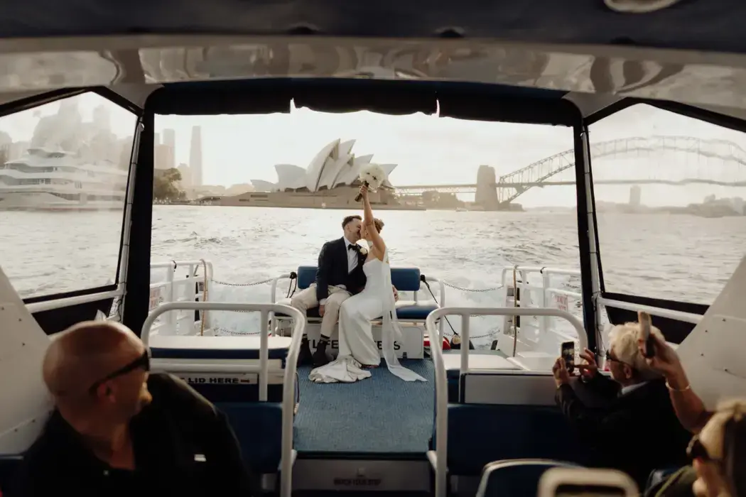 wedding couple on back of boat with Sydney Opera House in view